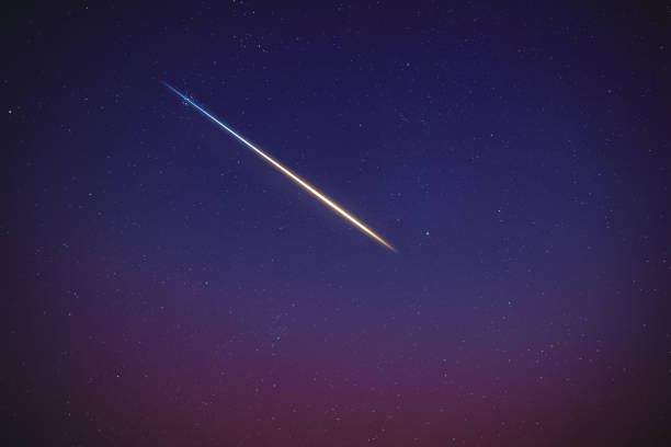istock Stars, meteor trail on evening sky. 1389466085