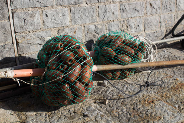 evocative image of the anchor point for boats in the port in a small\nfishing village in Sicily, Italy