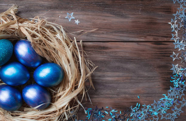 istock Blue Easter eggs in a nest on a wooden background. Easter card with a place to copy the text. The concept of bright Easter. 1389468615