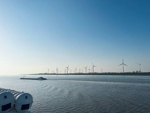 istock Row of wind turbines in the harbor 1389468838