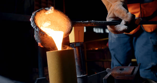 istock Man pouring steel into cast 1389470254