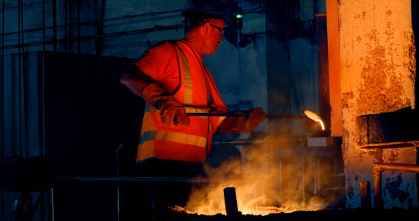 istock Man melting metal in foundry 1389470259