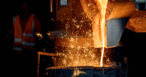 istock Man looking at molding metal 1389470264