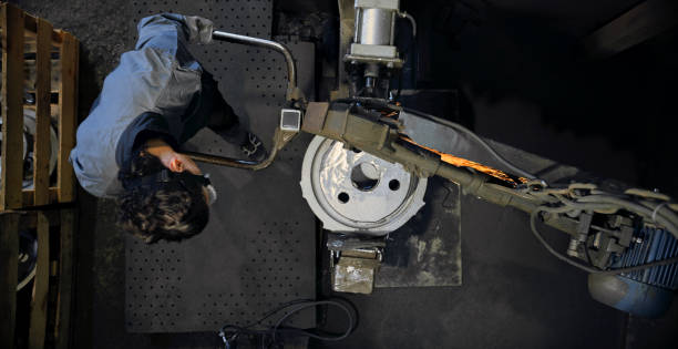 istock Worker grinding in steel mill 1389470313