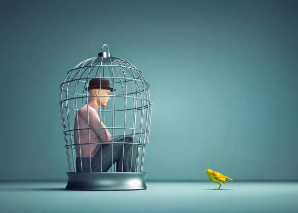 Man inside a bird cage with a yellow bird out. Social justice and freedom concept. This is a 3d render illustration