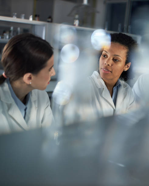 istock Young female scientists talking in laboratory. 1389471860