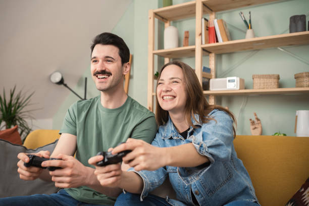 istock Husband and wife gaming and having fun 1389474322