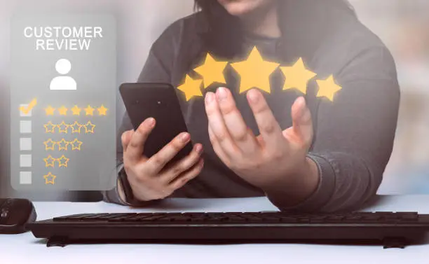 Photo of Woman rating a service on smartphone. Customer review satisfaction feedback concept.