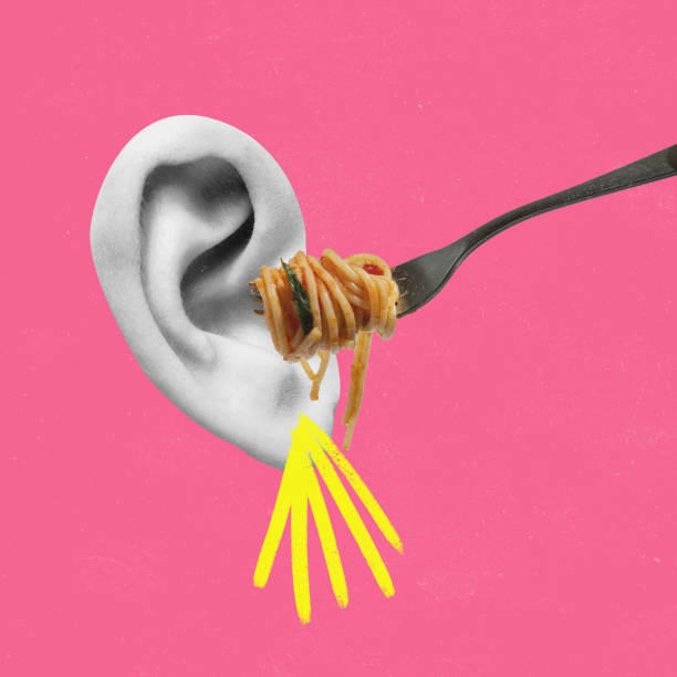 istock Contemporary art collage. Spaghetti on fork moving to human ear symbolizing fool 1389476019