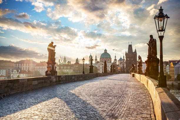 Charles Bridge in Prague, Czech Republic at sunrise Charles Bridge in Prague, Czech Republic at sunrise with historic statues charles bridge prague stock pictures, royalty-free photos & images