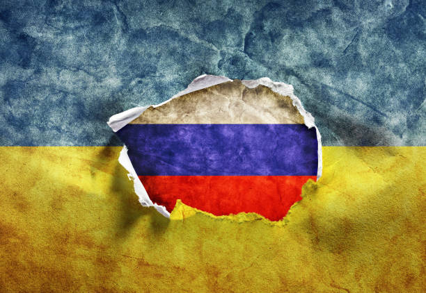 istock Ukraine and Russia war. Torn Ukrainian flag 1389478151