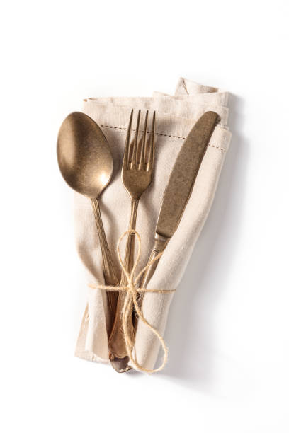 istock Cutlery. A spoon, a fork, and a knife in a blue napkin on a white background 1389478268