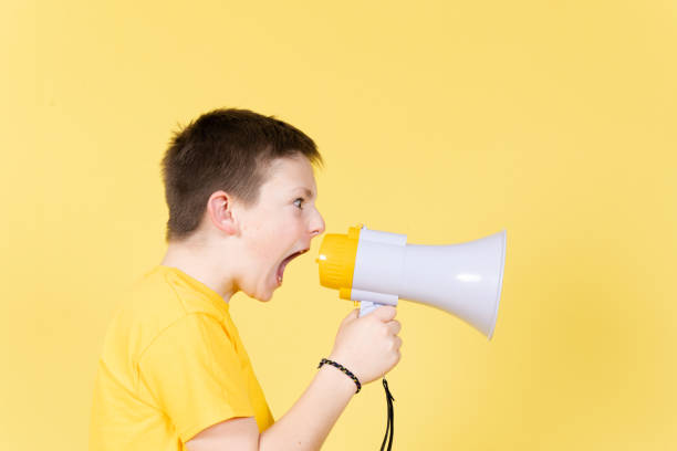 istock Angry boy yelling on loudspeaker 1389478554