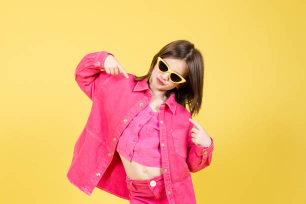 istock Arrogant little girl pointing herself isolated on yellow 1389478757