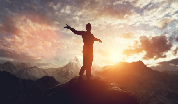 istock Man walking and balancing on mountain at sunset. 1389479440