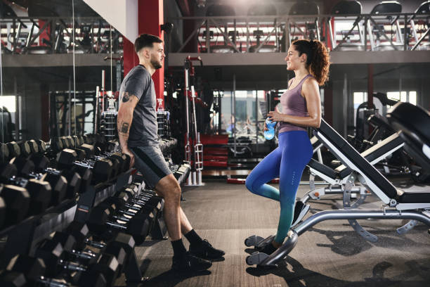 istock Athletic couple communicating while having a break in a gym. 1389479615