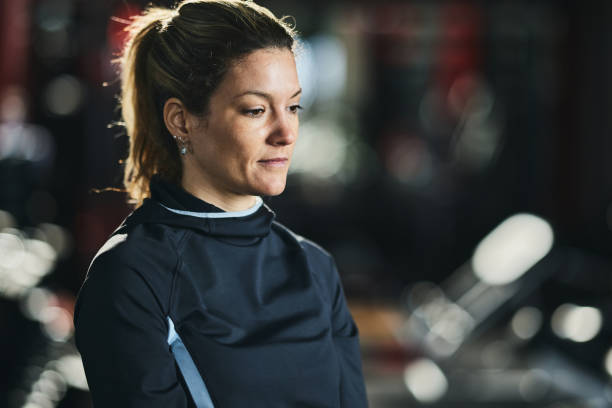istock Pensive athletic woman taking a break in a gym. 1389479744
