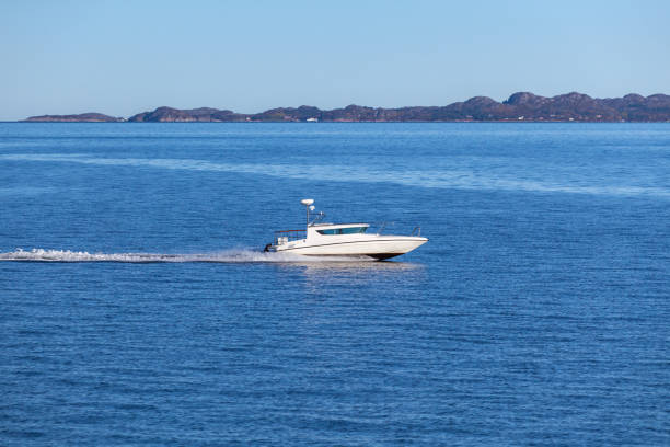 istock Fast white motor boat sails Norwegian Sea 1389479923