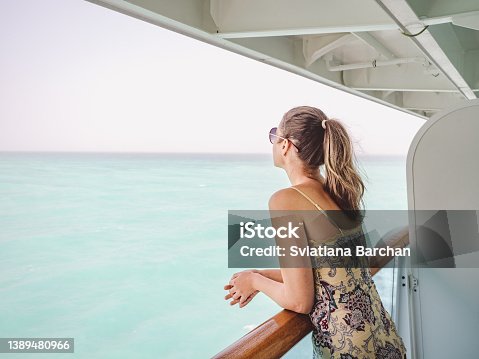 istock Beautiful woman standing on the empty deck 1389480966