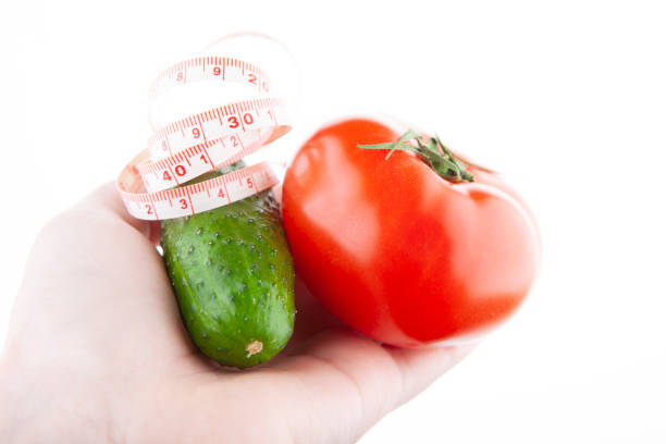 image of cucumber tomato hand white background
