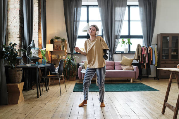 istock Woman with prosthesis dancing at home 1389483124