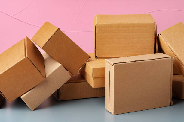 istock Set of cardboard boxes on pink background 1389483505