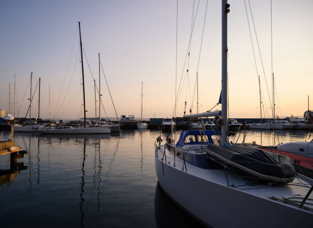 istock Yachts and boats reflected in water. 1389483629