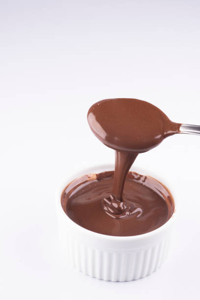 istock pouring chocolate and hazelnut cream with spoon isolated on white background 1389485129