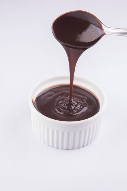 istock pouring dark chocolate cream with spoon isolated on white background 1389485145