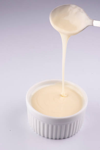 istock pouring white chocolate cream with spoon isolated on white background 1389485201