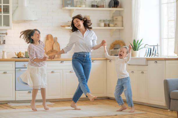 istock Mom and her daughters are dancing. 1389485261