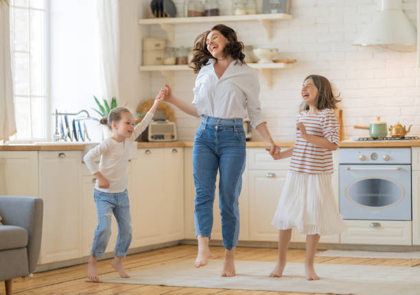 istock Mom and her daughters are dancing. 1389485270