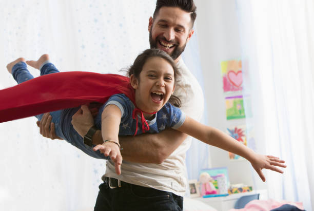 istock Father and daughter playing together 1389486429
