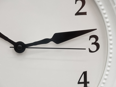 Sepia toned image of an old clock face isolated on a white background