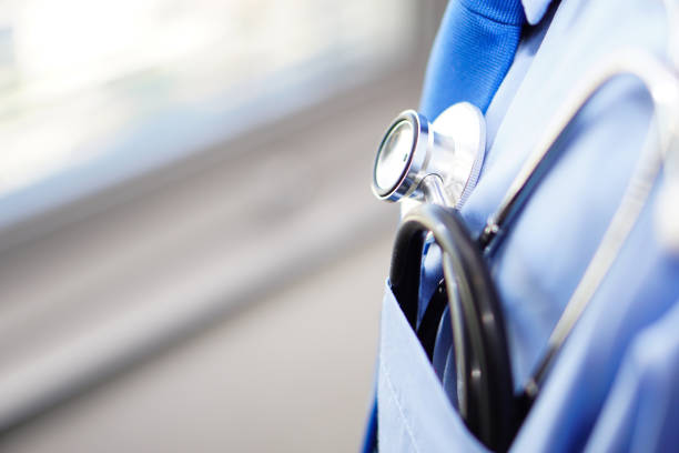 istock Male doctor in blue shirt with a stethoscope. 1389487875