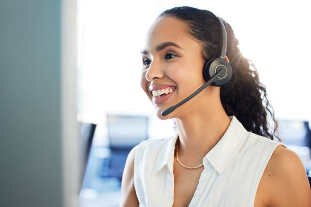 istock Shot of an attractive young call centre agent sitting alone in the office and using her computer 1389488039