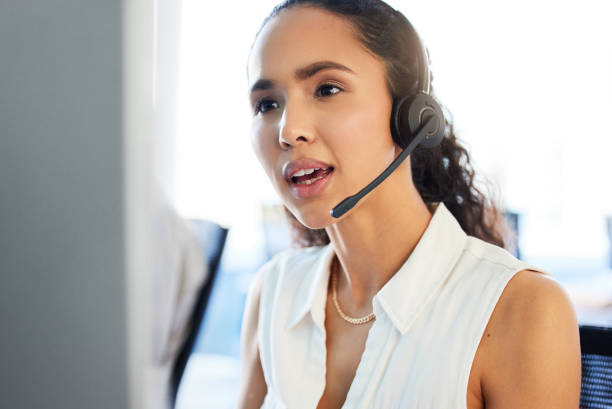 istock Shot of an attractive young call centre agent sitting in the office and using her computer 1389488042
