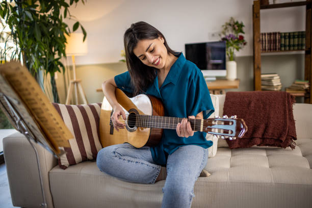 istock Playing a guitar at home 1389489408