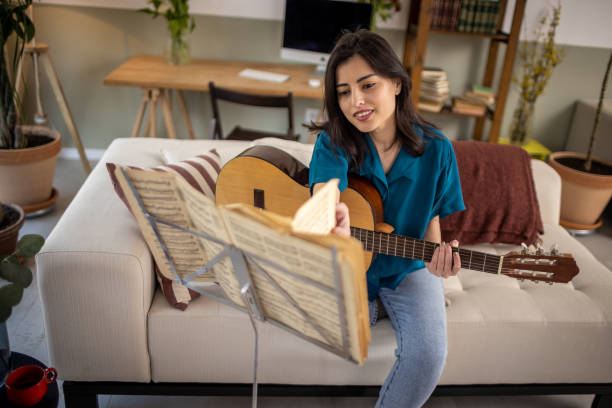 istock Playing a guitar at home 1389490487