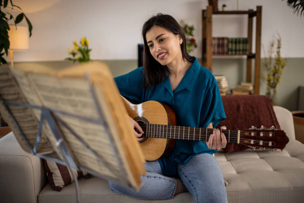 istock Playing a guitar at home 1389490581