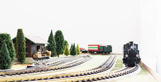 Model railway featuring agricultural siding and steam train, with workers preparing farm products.