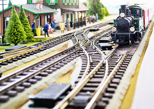 Model railway featuring rustic station and steam train.