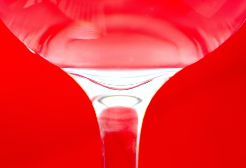 Carbonated bubbles on glass - red background.