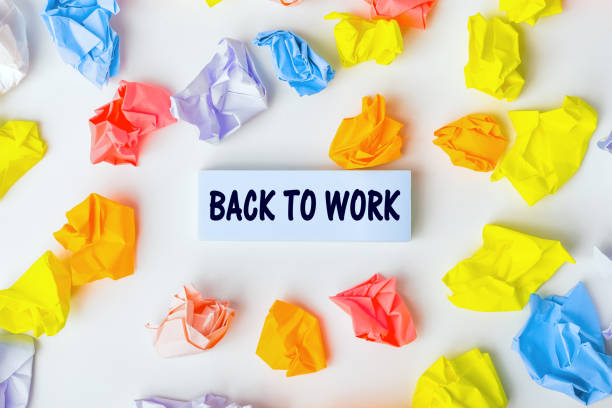 istock Blue sticky note with the text Back to work and some colorful crumpled paper balls around it on white background. Business concept. Still life, Flatlay design, View from above 1389496094
