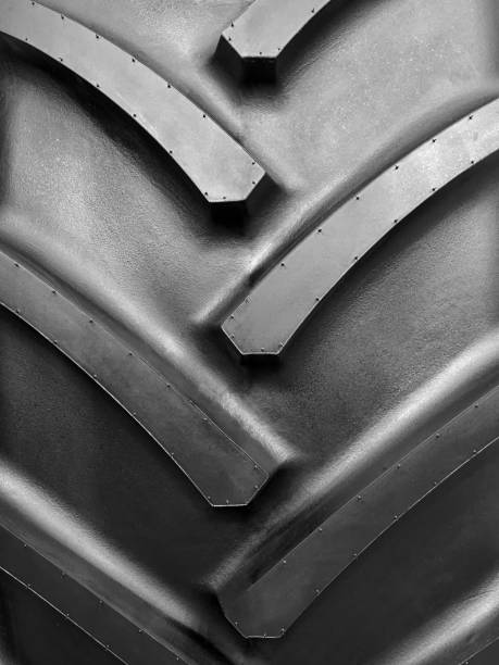 Closeup of the tread of a large rubber wheel stock photo