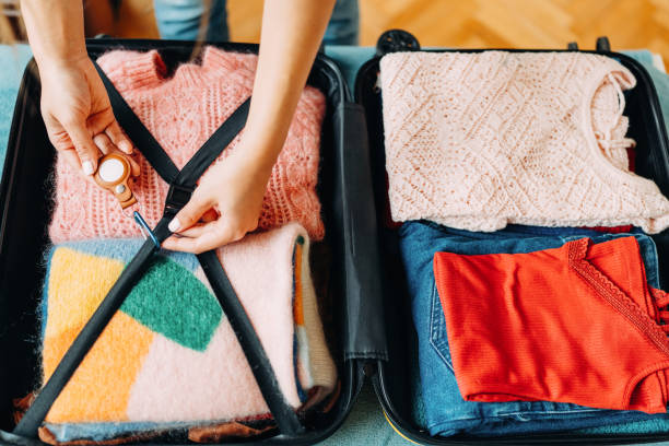 istock Woman packing suitcase for travel 1389496288