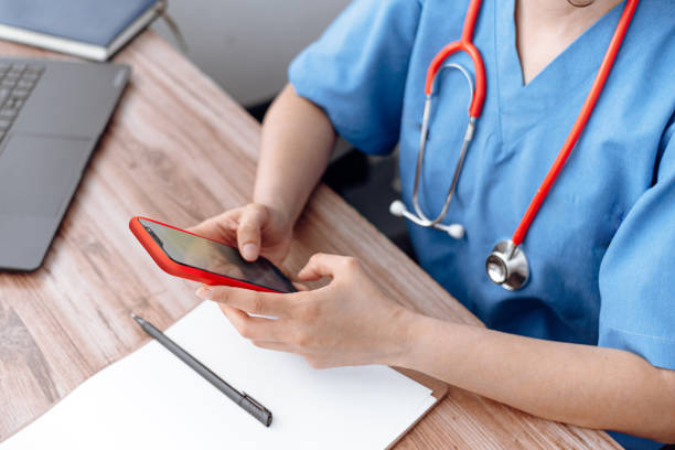 istock doctor using mobile phone, health staff using a phone. medical service online concept. 1389496332