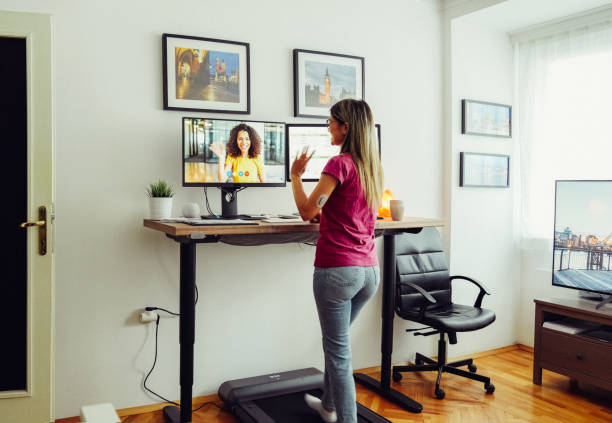 istock Standing desk home office with under desk treadmill 1389496381