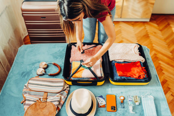 istock Woman packing suitcase for travel 1389496431