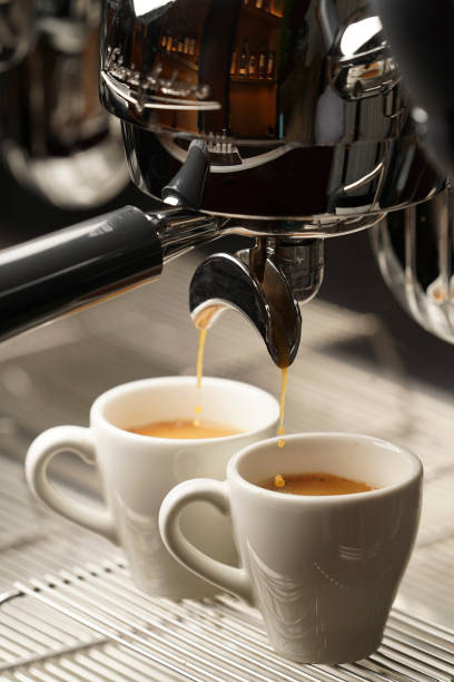 istock Coffee machine pouring coffee, close-up 1389497318